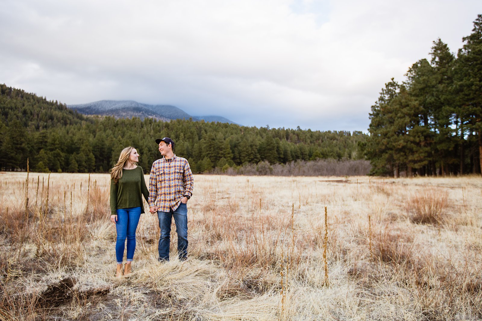 Couple looking at each other during their Flagstaff engagement session by photographer PMA Photography.