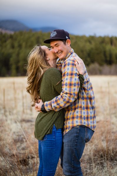 Couple laughing together during their engagement session by Flagstaff engagement photographer PMA Photography.