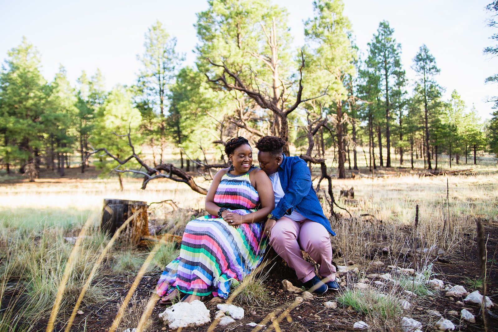 Same sex couple pose together during their Flagstaff engagement session in the woods by Flagstaff wedding photographer PMA Photography.