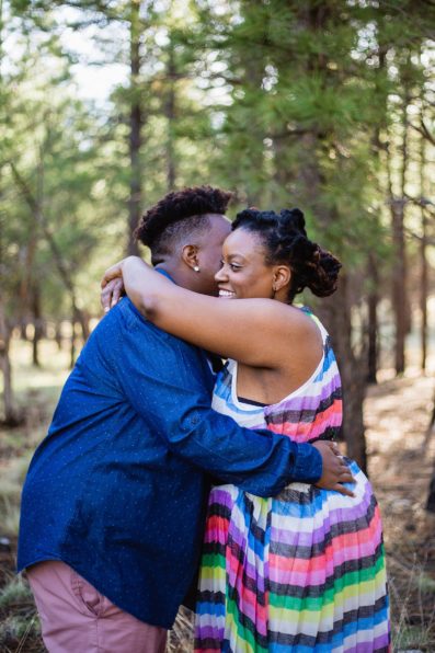 LGBT couple share an intimate moment during their sunrise engagement session by Flagstaff wedding photographer PMA Photography.