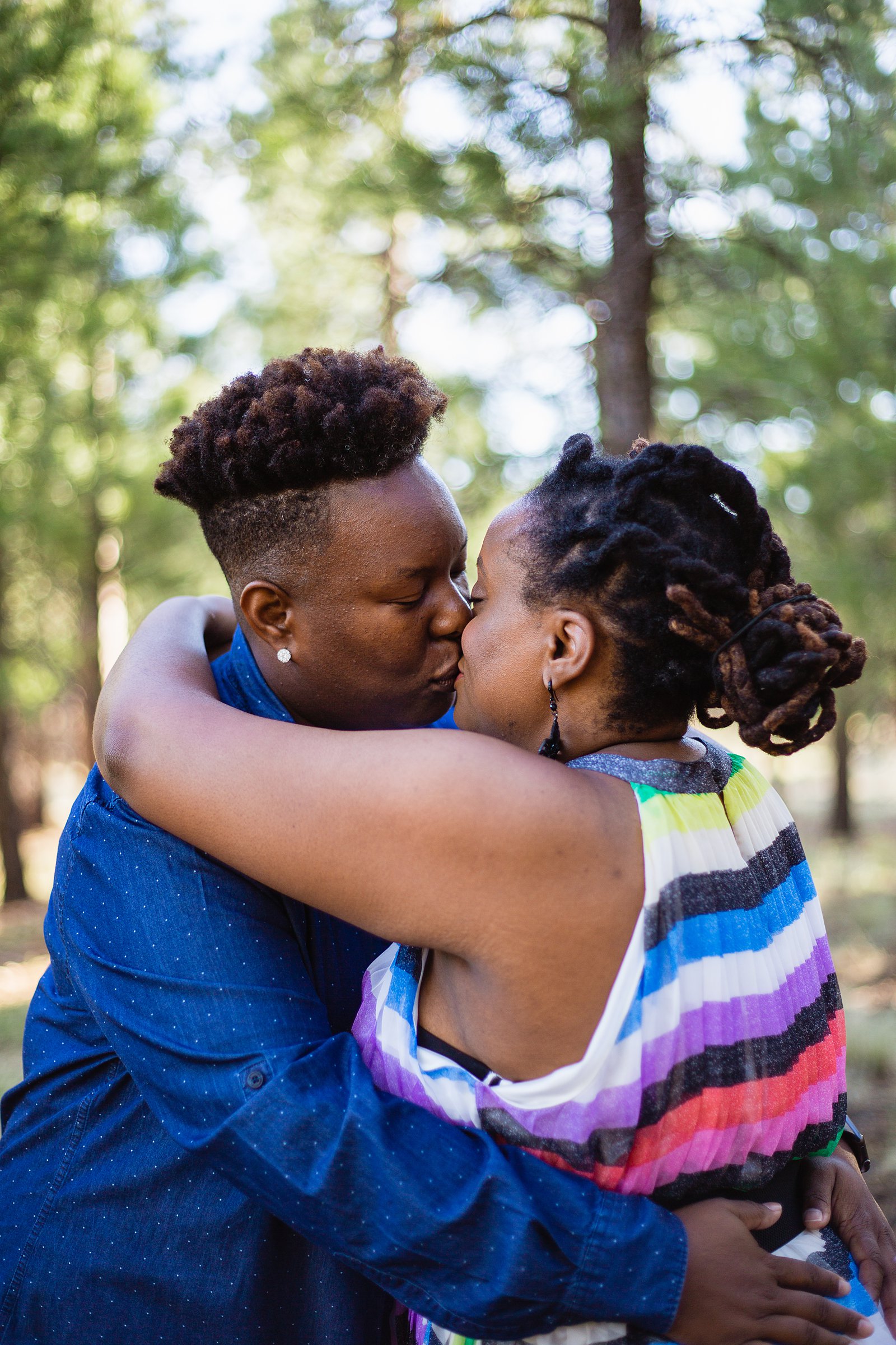 LGBT couple share a kiss during their Flagstaff engagement session by Arizona wedding photographer PMA Photography.