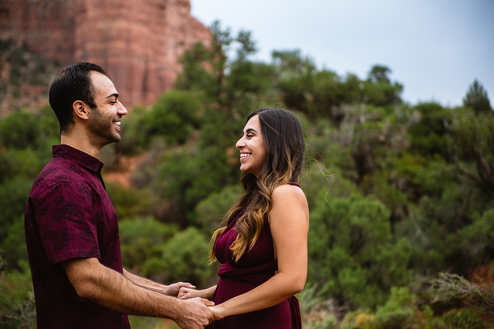 Couple laugh together during their Sedona engagement session by Arizona engagement photographer PMA Photography.