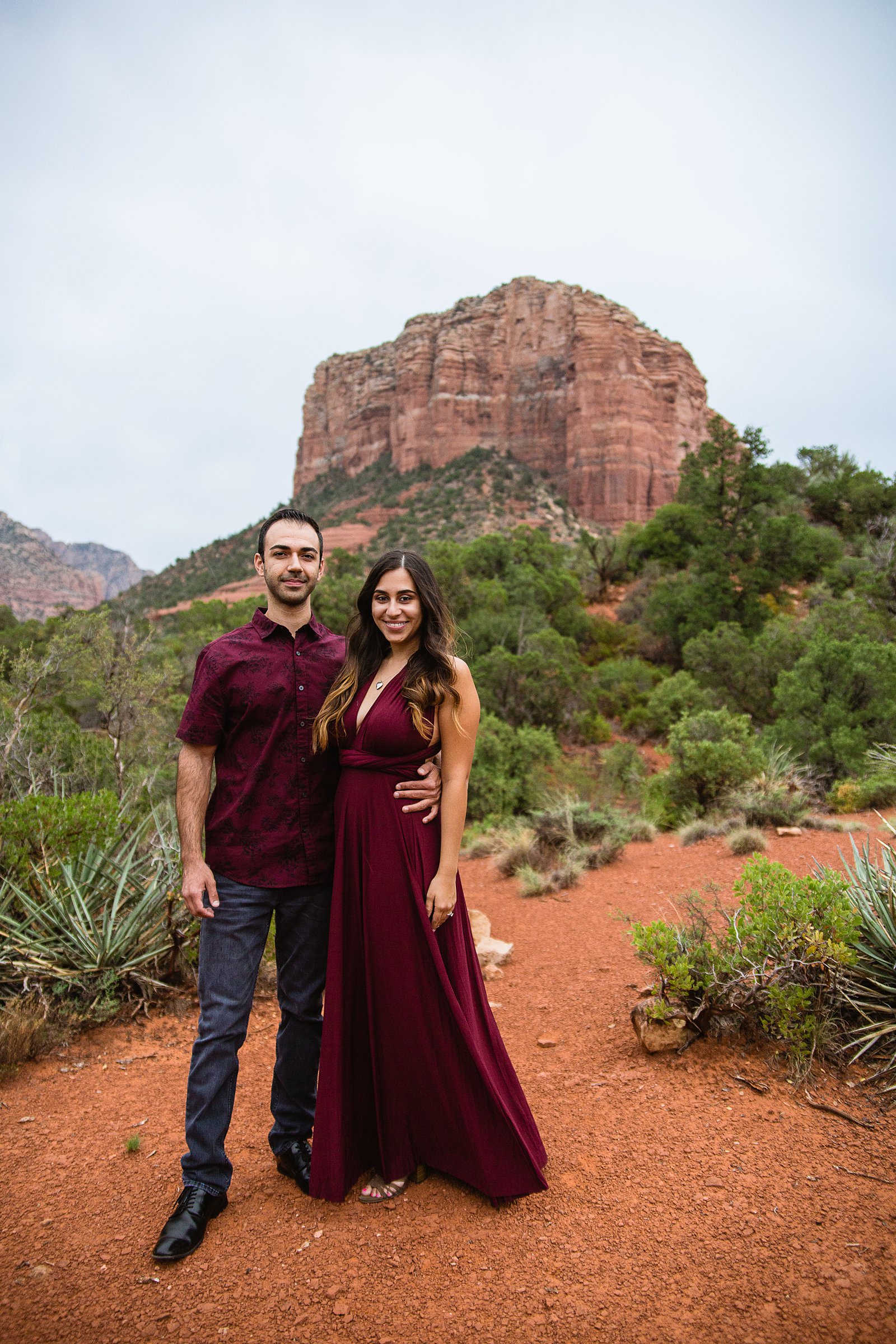 Couple pose for their Bell Rock Monsoon engagement session by Sedona wedding photographer PMA Photography.