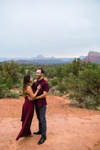 Couple laugh together during their Bell Rock Monsoon engagement session by Sedona engagement photographer PMA Photography.