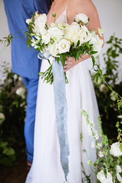 Bride's simple white bouquet with blue ribbon by PMA Photography.