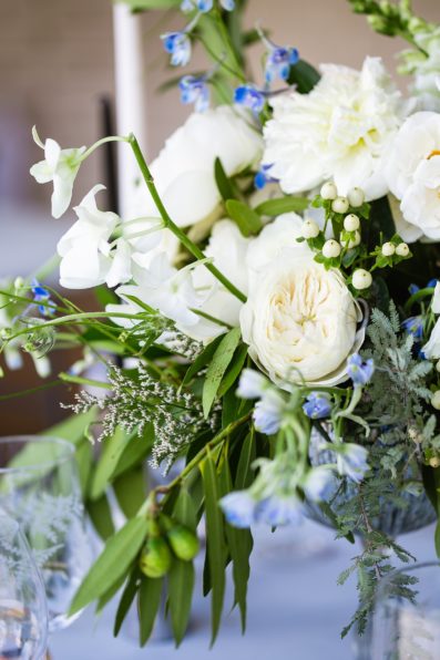 White and blue floral centerpieces at Gather Estate wedding reception by Phoenix wedding photographer PMA Photography.