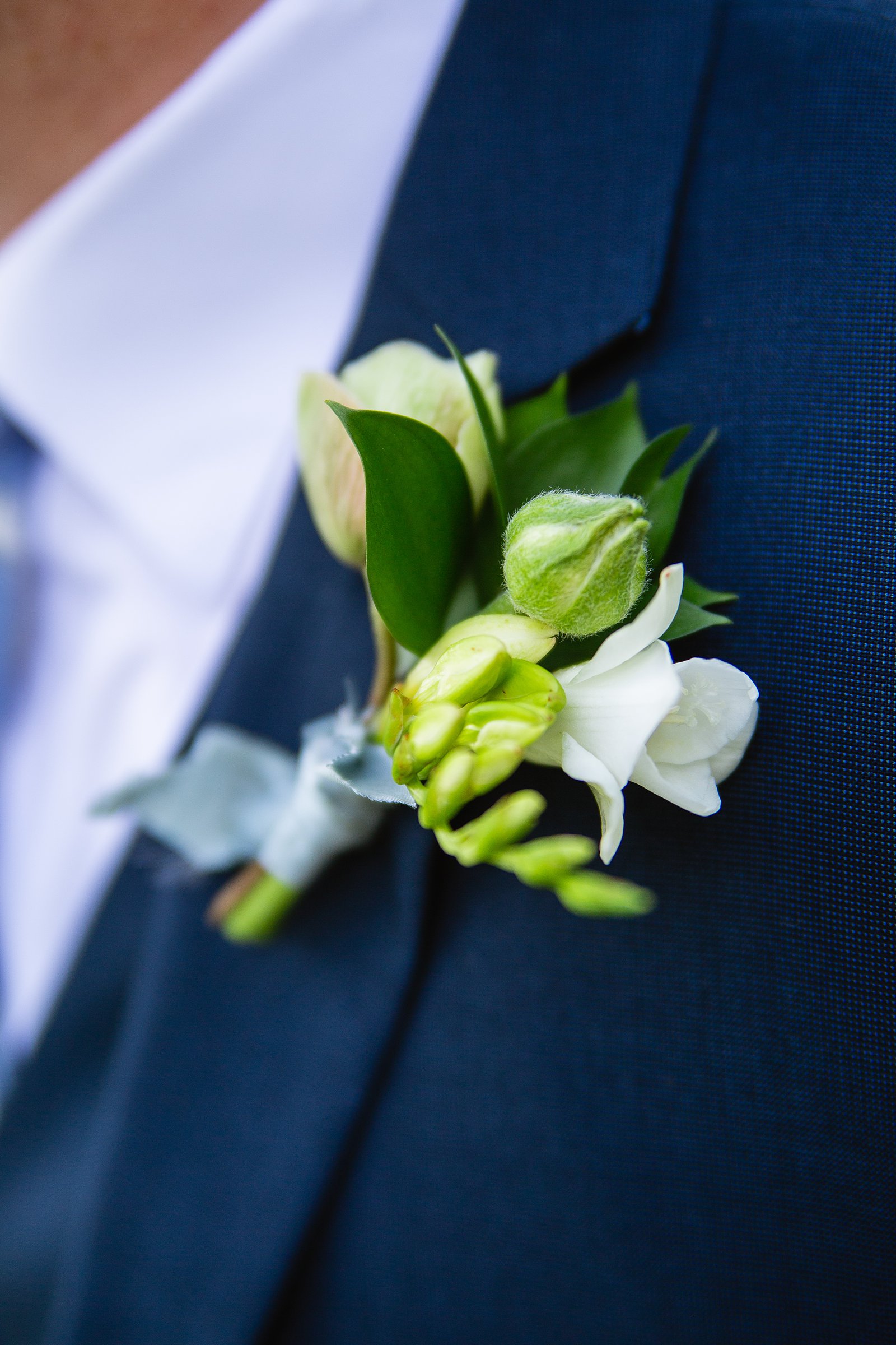 Groomsmen simple white and green boutonniere by PMA Photography.