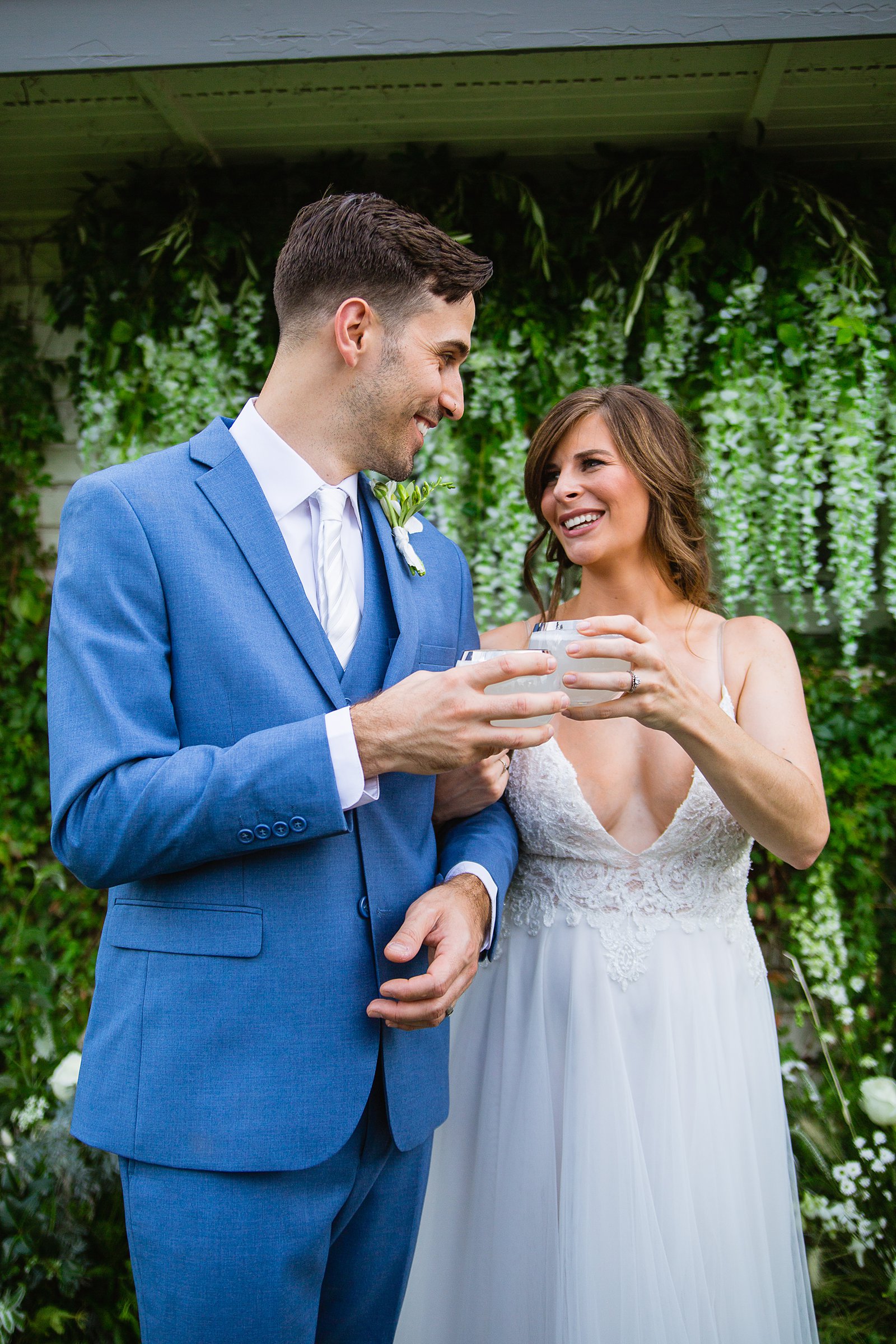 Bride and groom toast with signature wedding cocktails by Arizona wedding photographers PMA Photography.