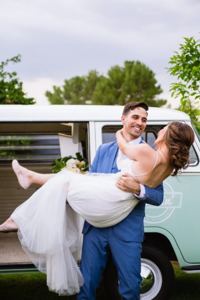 Bride and groom having fun together with VW Cruisin' Photo Booth Bus booth at Gather Estate wedding by Arizona wedding photographers PMA Photography.