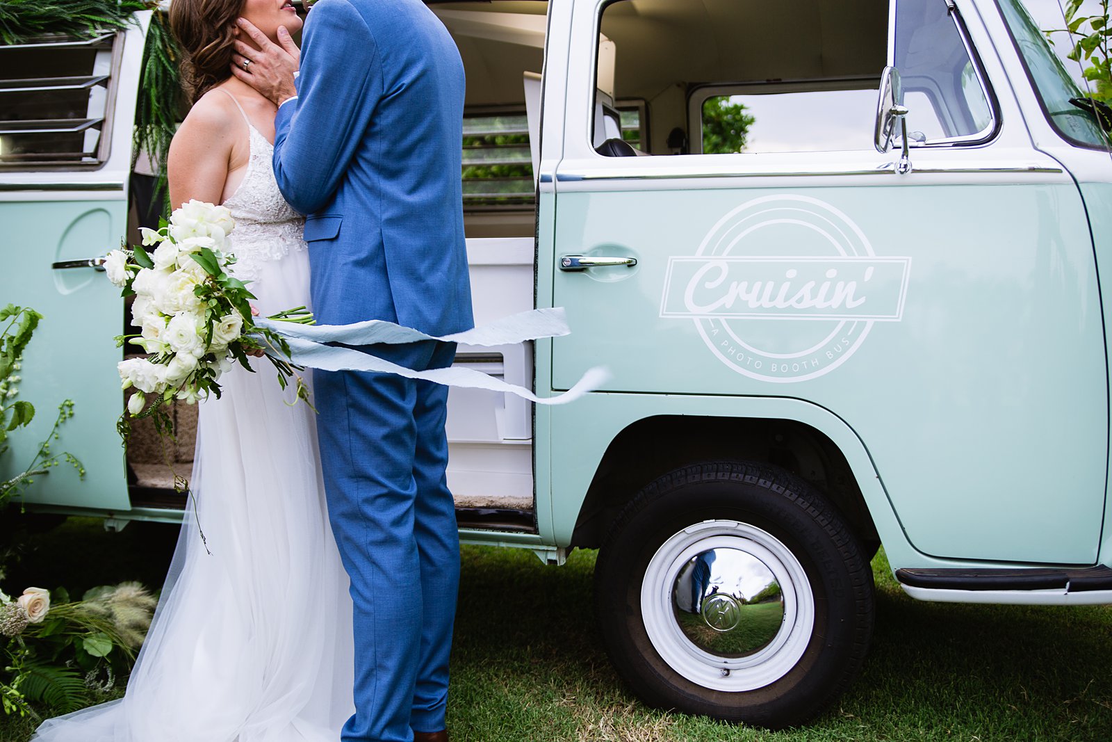 Bride and groom together with VW Cruisin' Photo Booth Bus booth at Gather Estate wedding by Arizona wedding photographers PMA Photography.