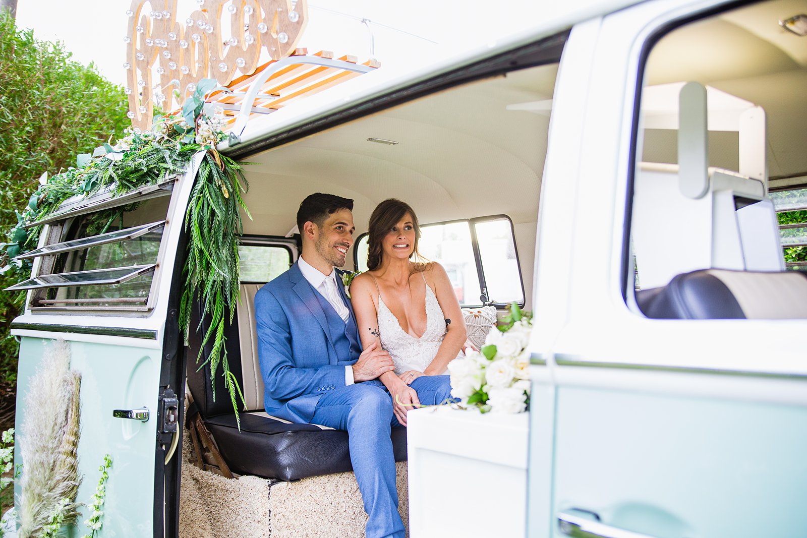 Bride and groom together in the VW Cruisin' Photo Booth Bus booth at Gather Estate wedding by Arizona wedding photographers PMA Photography.