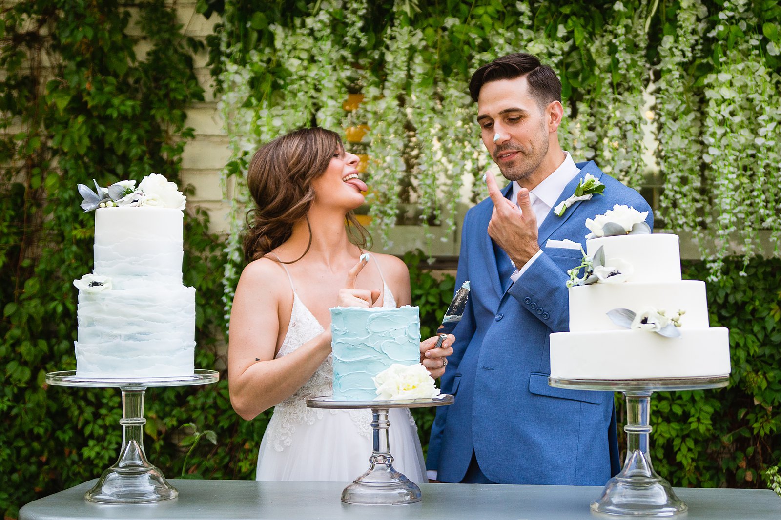Bride and groom cutting their wedding cake at their Gather Estate wedding reception by Arizona wedding photographer PMA Photography.