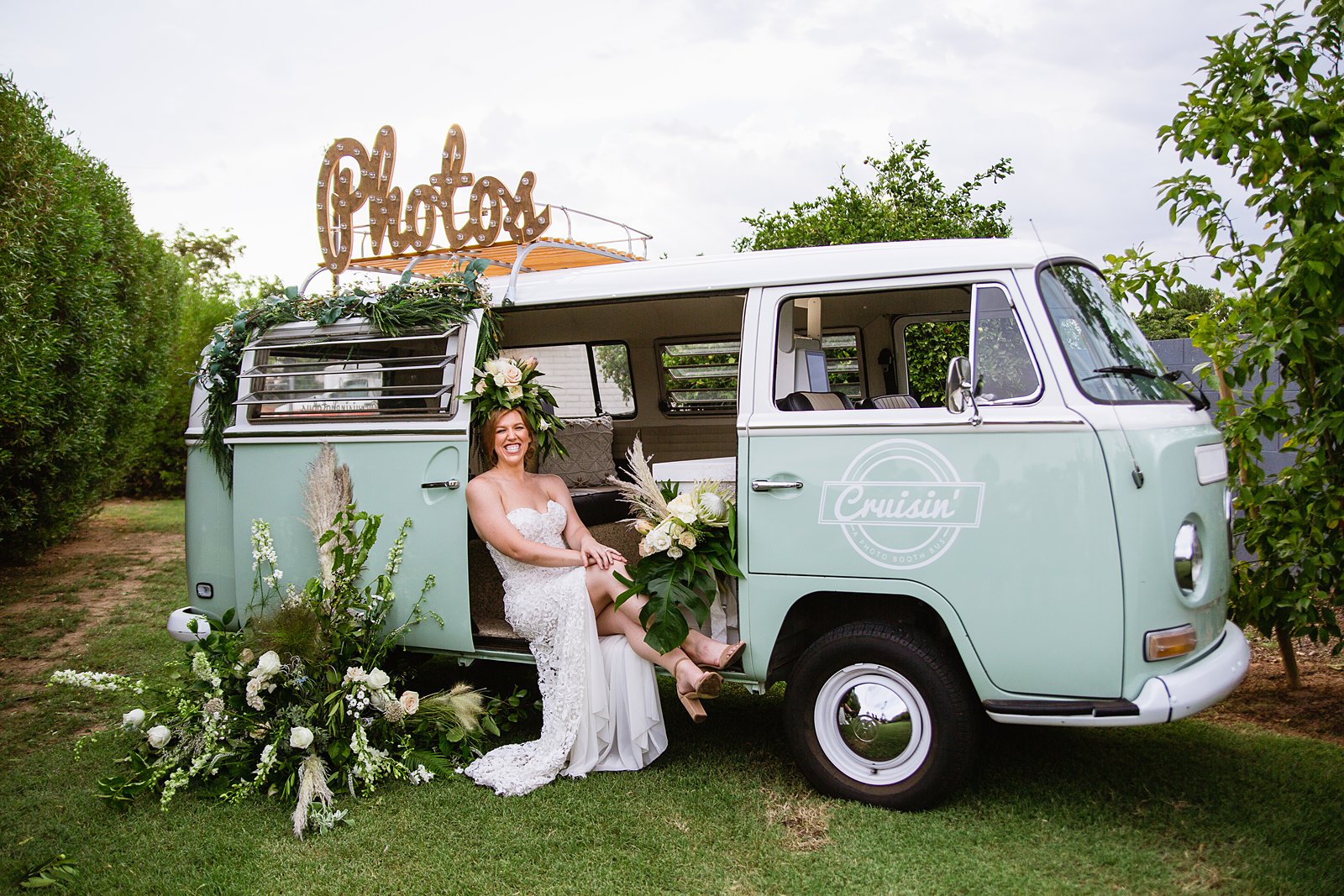 Bride laughing in the Cruisin' VW Photo Booth Bus at a Gather Estate wedding reception by Phoenix wedding photographer PMA Photography.