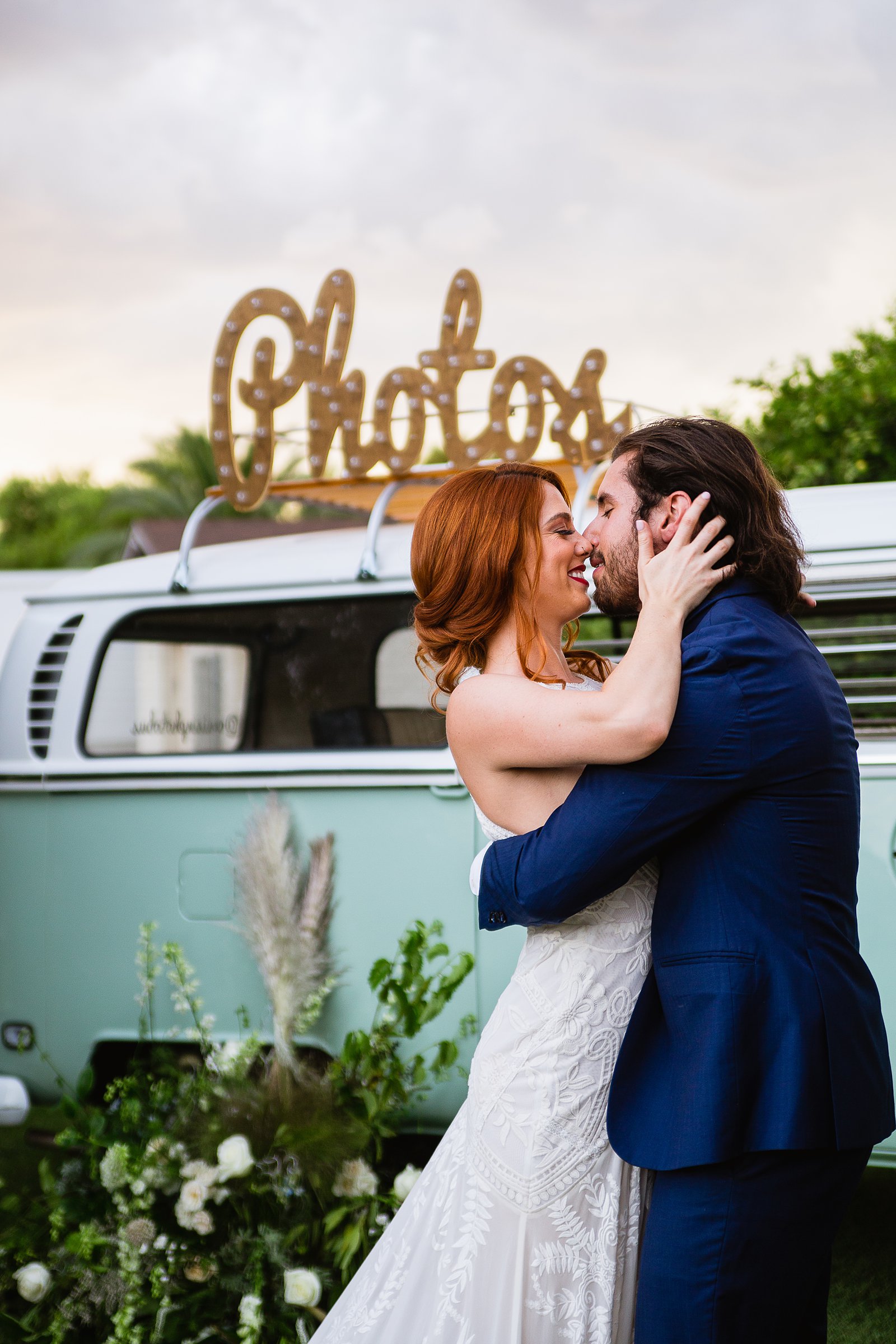 Bride and groom together with VW Bus photo booth at Gather Estate wedding by Arizona wedding photographers PMA Photography.