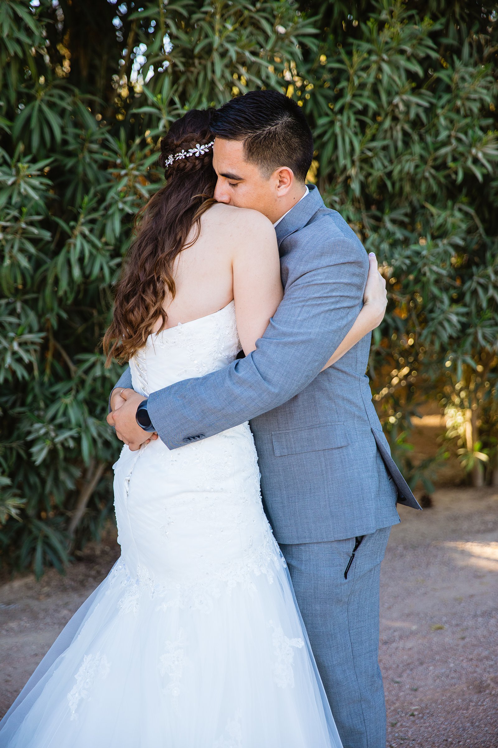 Bride and groom share an intimate moment during their first look at Schnepf Farms by Arizona wedding photographer PMA Photography.