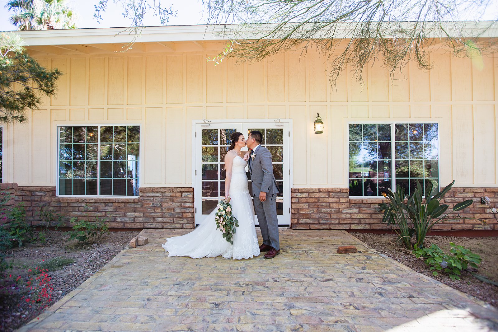 Bride and groom pose during their Schnepf Farms wedding by Arizona wedding photographer PMA Photography.