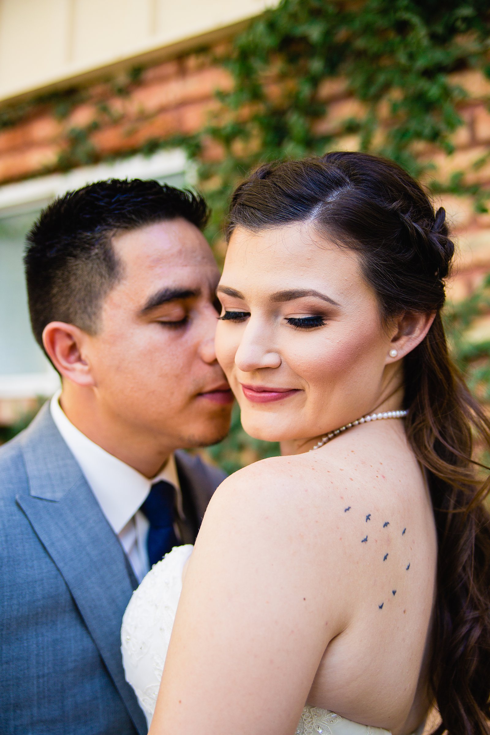 Bride and groom share an intimate moment at their Schnepf Farms wedding by Arizona wedding photographer PMA Photography.