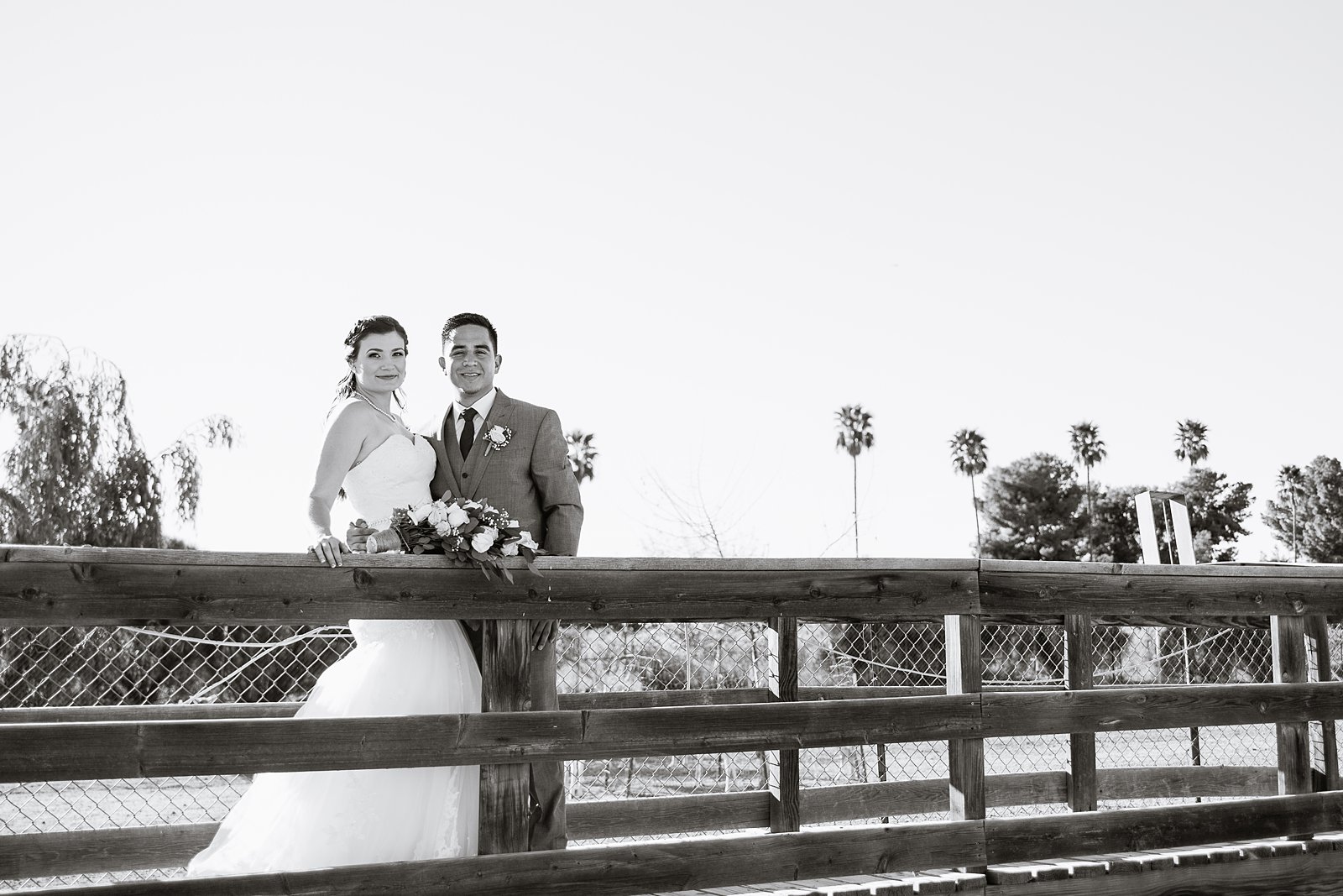 Bride and groom pose for their Schnepf Farms wedding by Queen Creek wedding photographer PMA Photography.