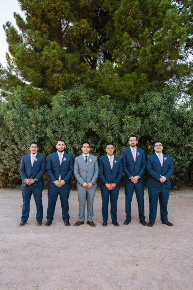 Groom and groomsmen together at a Schnepf Farms wedding by Arizona wedding photographer PMA Photography.