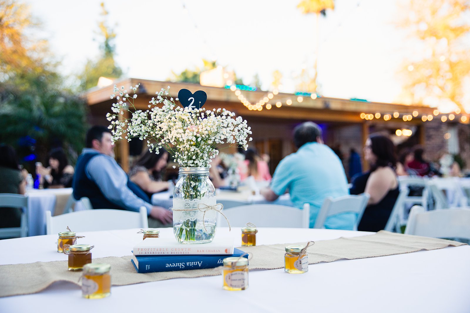 Rustic centerpieces at Schnepf Farms wedding reception by Queen Creek wedding photographer PMA Photography.