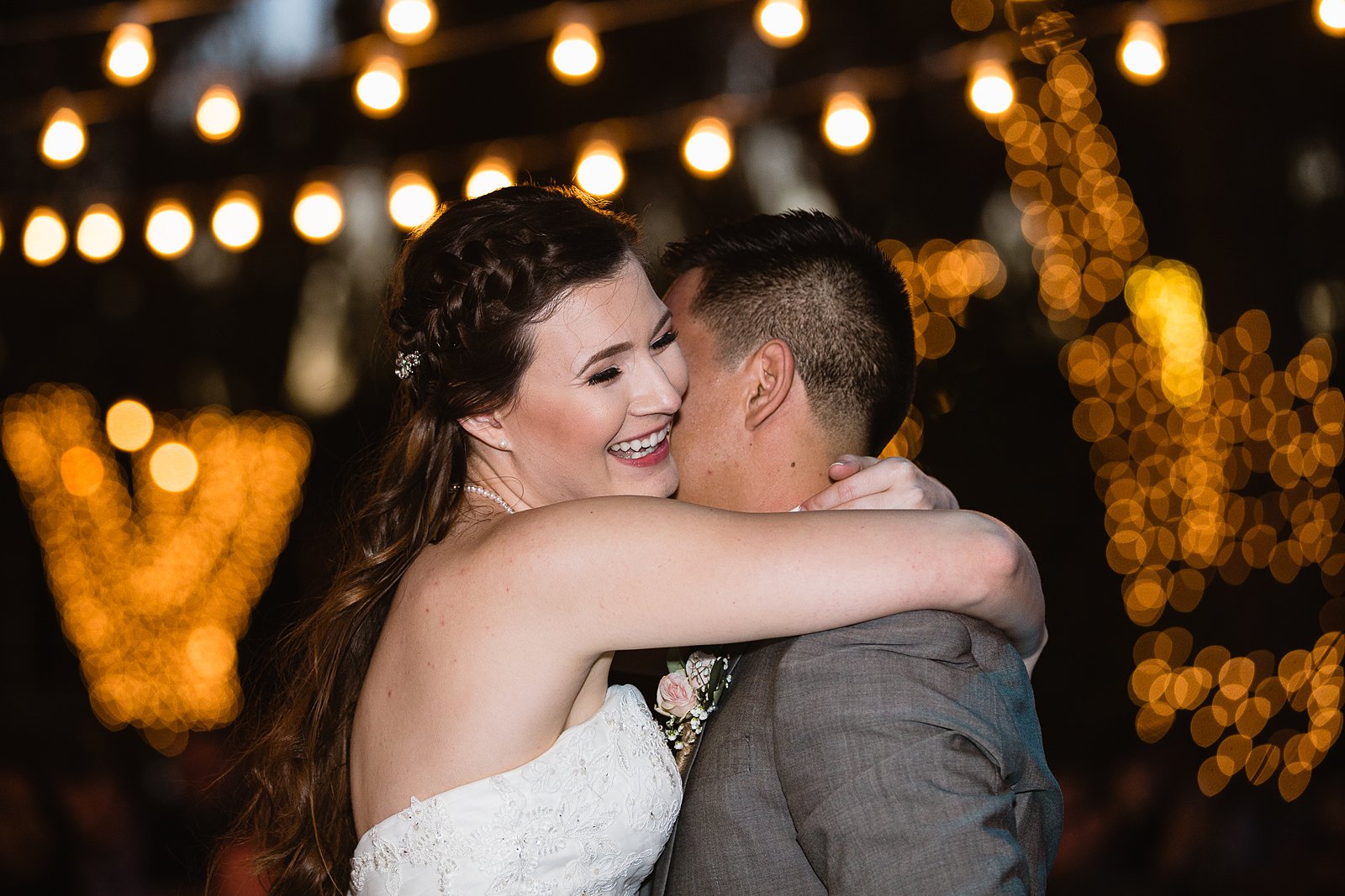 Bride and groom sharing first dance at their Schnepf Farms wedding reception by Arizona wedding photographer PMA Photography.