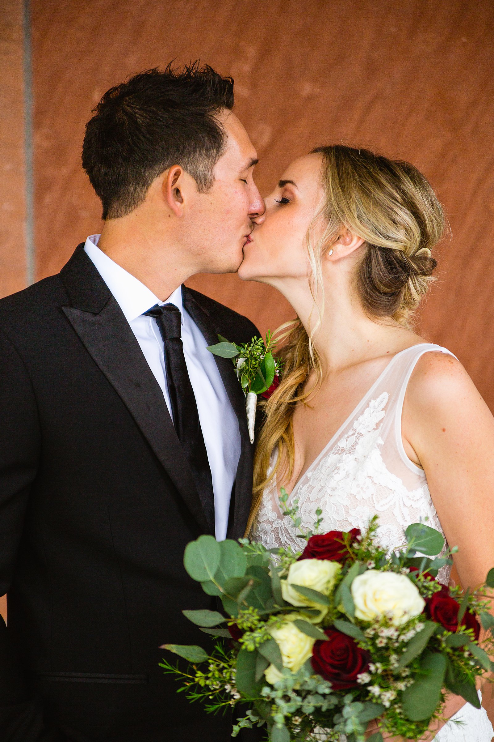 Bride and groom share a kiss during their Flagstaff Courthouse wedding by Flagstaff wedding photographer PMA Photography.