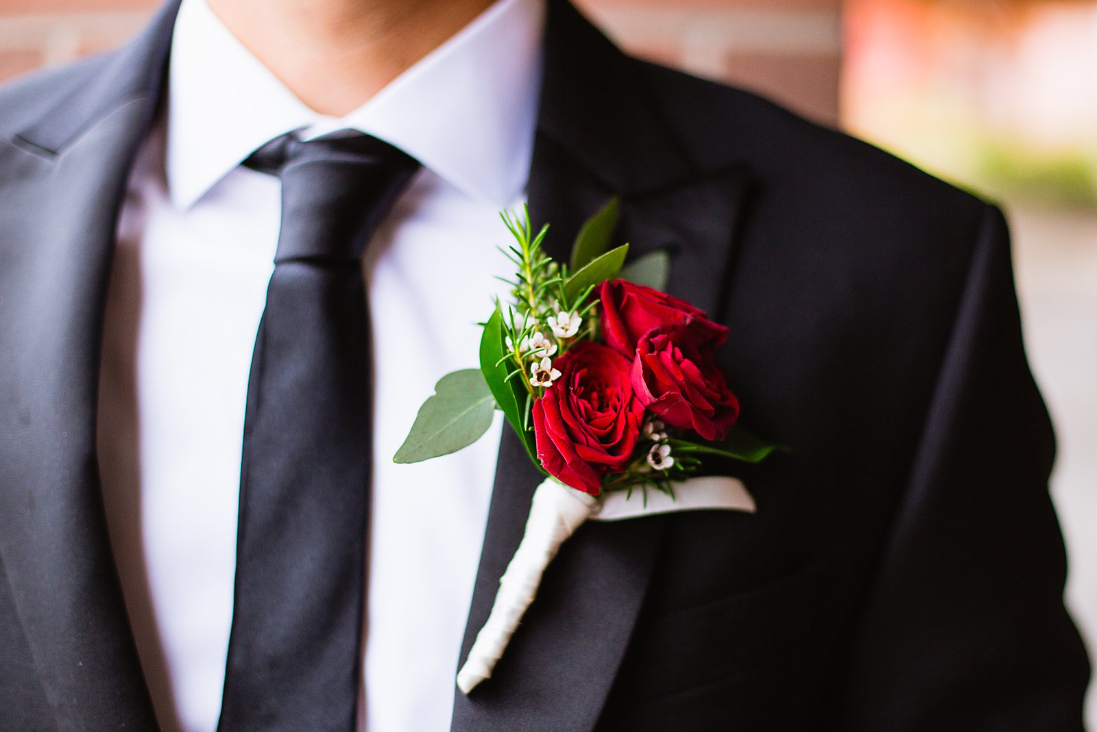 Groom's red rose boutonniere by PMA Photography.