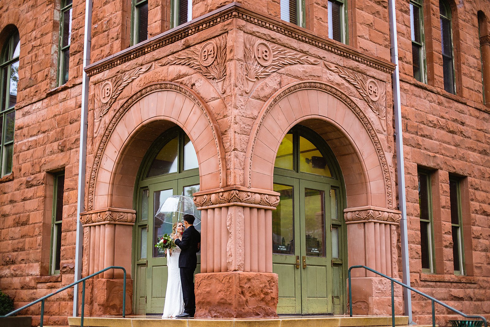 Bride and groom share an intimate moment during their rainy Flagstaff Courthouse wedding by Flagstaff wedding photographer PMA Photography.