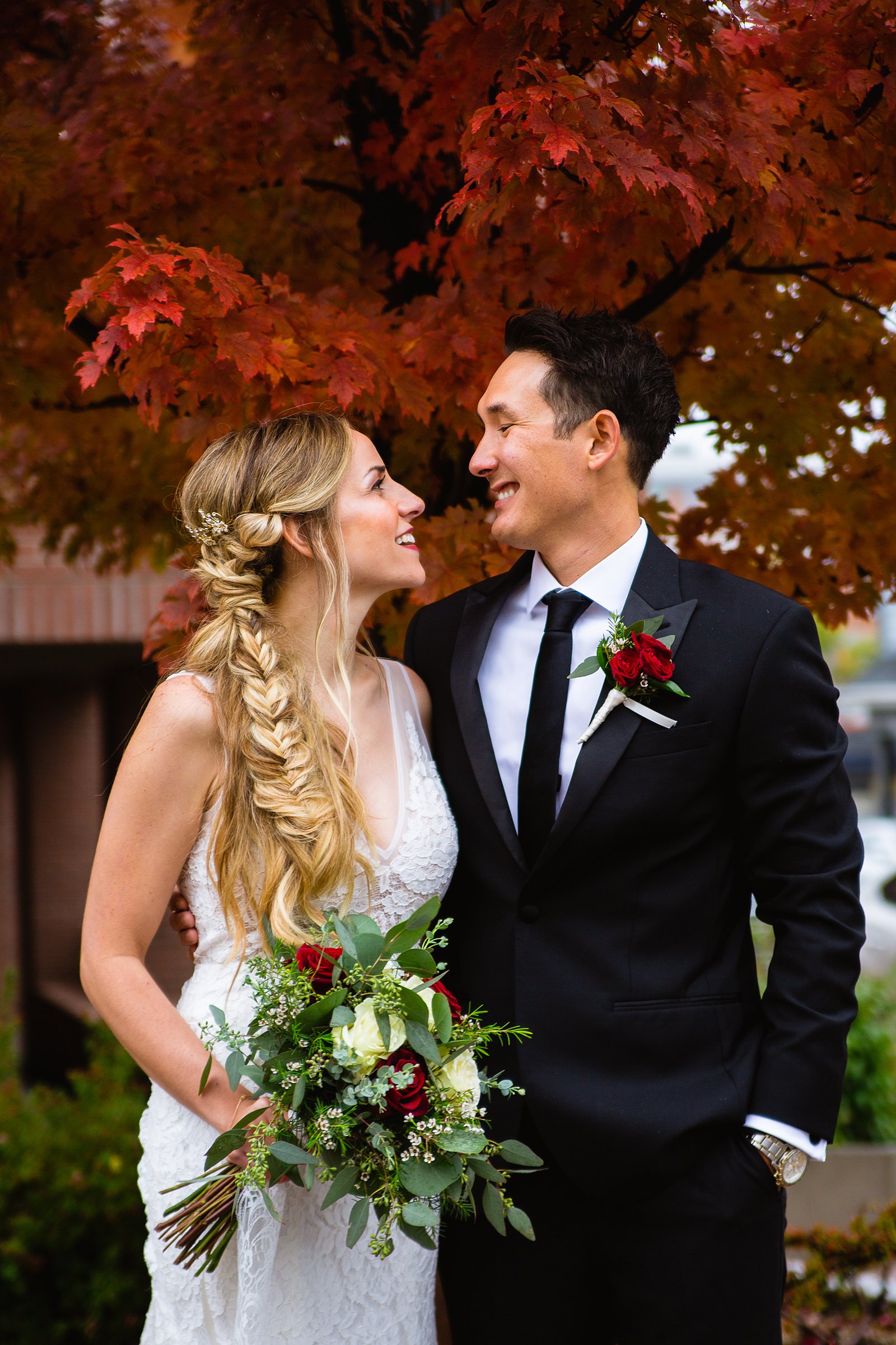 Bride and groom laughing together during their downtown Flagstaff wedding by Flagstaff wedding photographer PMA Photography.