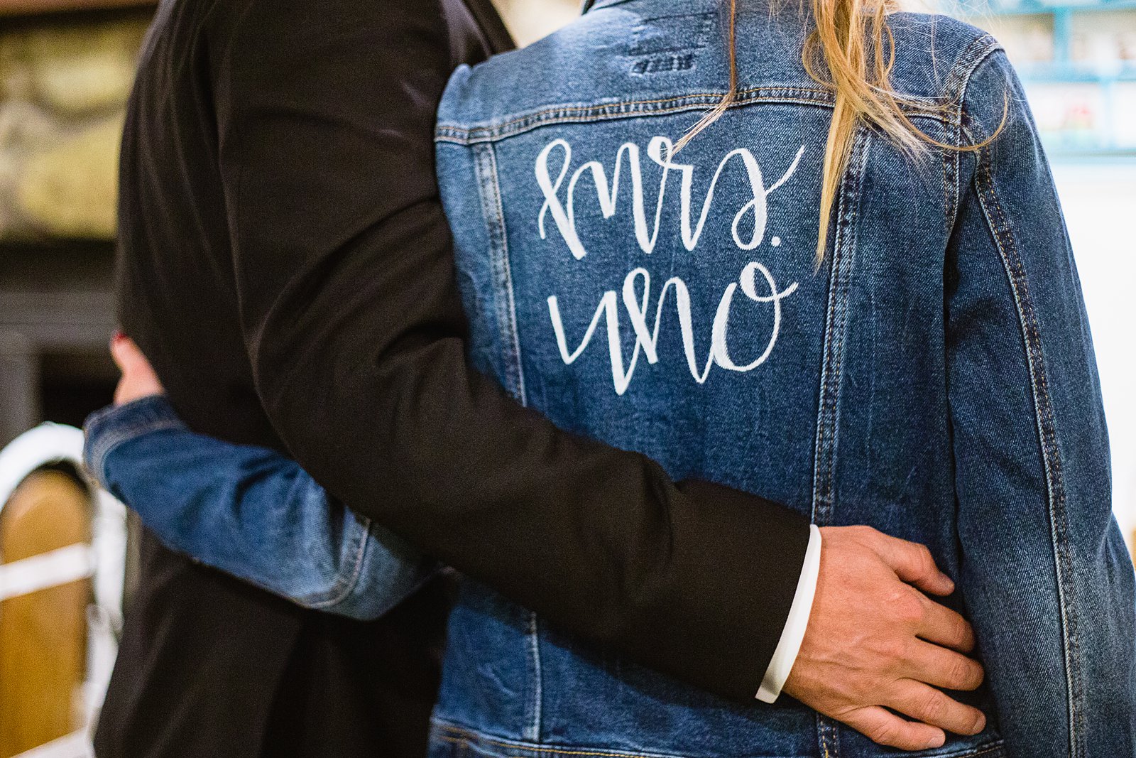Bride's custom Mrs. jeans jacket at her reception by PMA Photography.