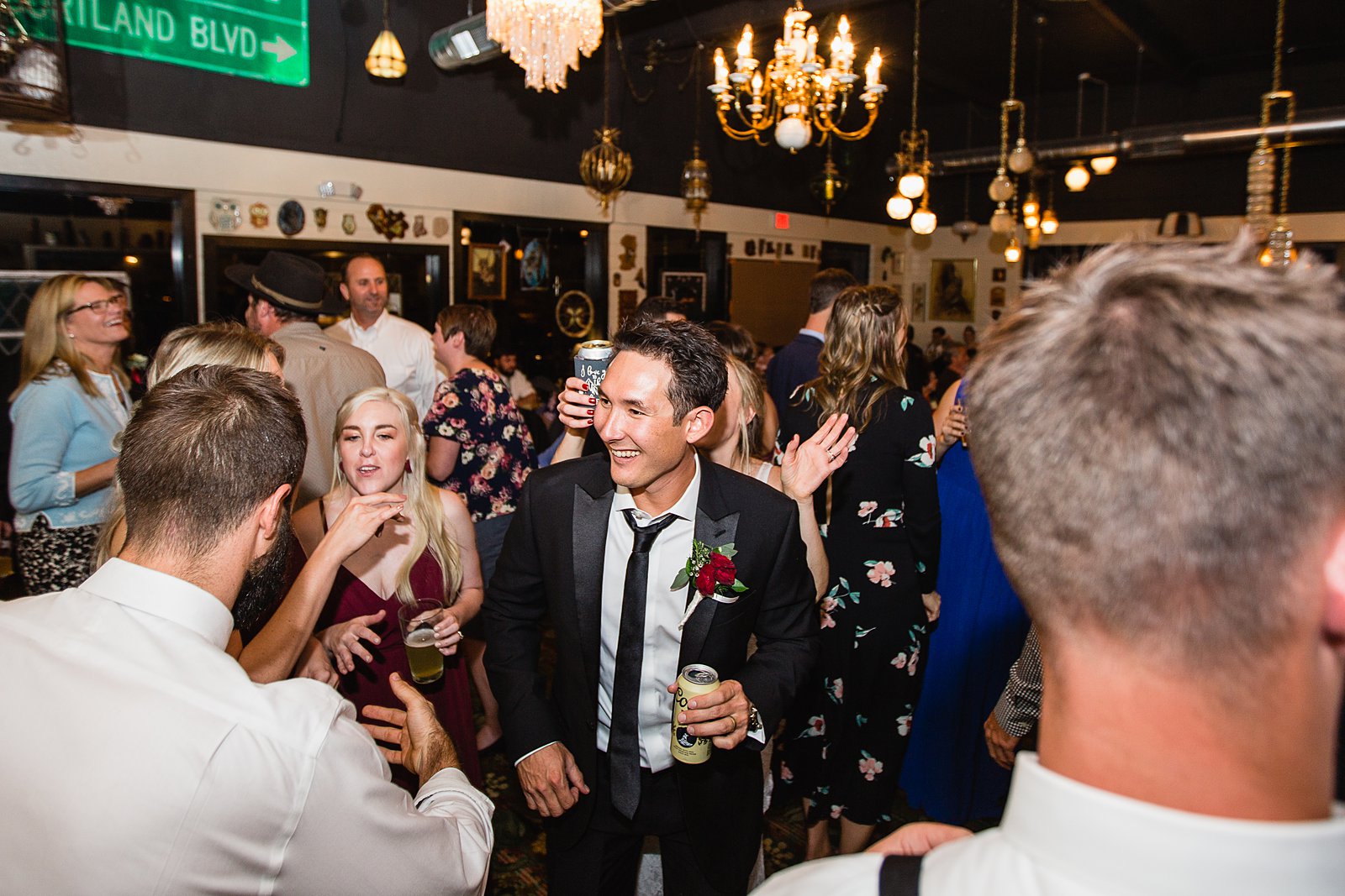 Bride and groom dancing with guests at their Toasted Owl wedding reception by Arizona wedding photographer PMA Photography
