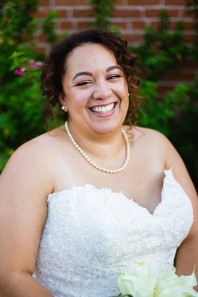 Bride laughing on her wedding day by PMA Photography.