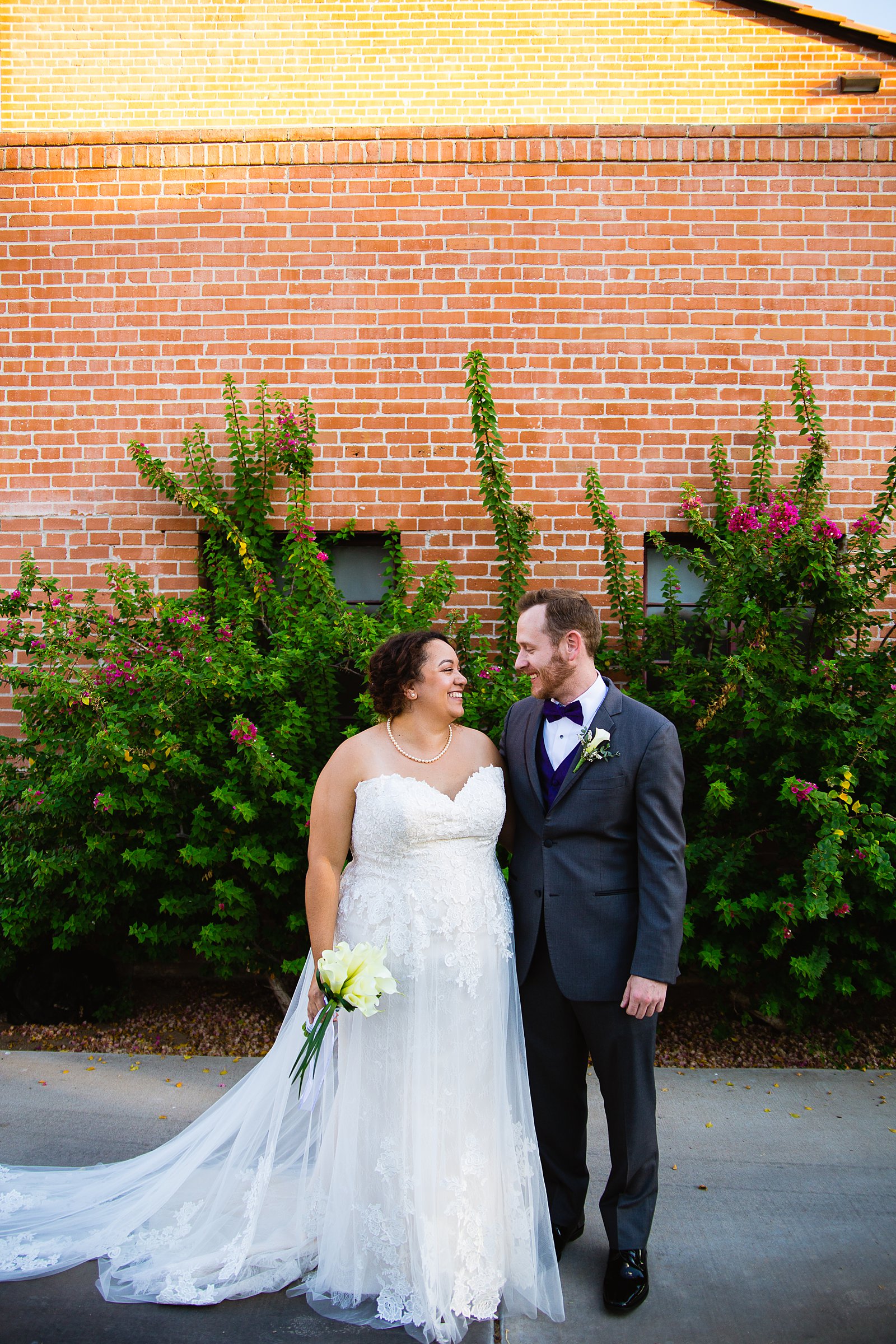 Bride and groom pose during their Encanto Park wedding by Arizona wedding photographer PMA Photography.