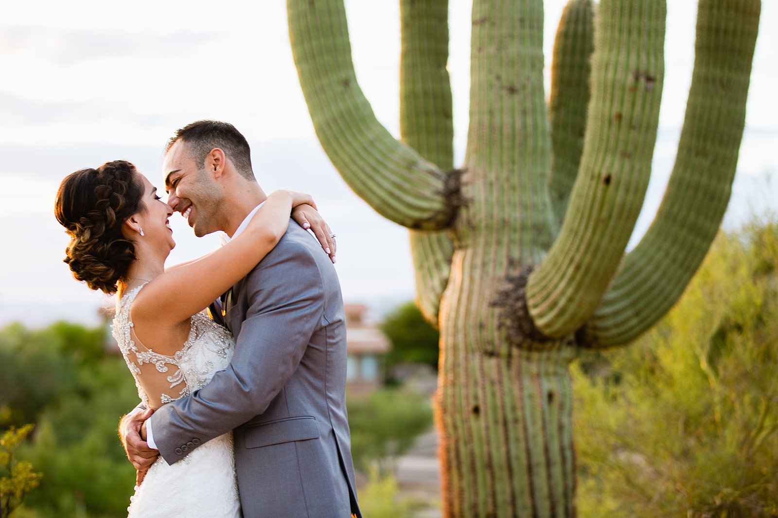 Bride and groom laughing together during their Troon North wedding by Arizona wedding photographer PMA Photography.