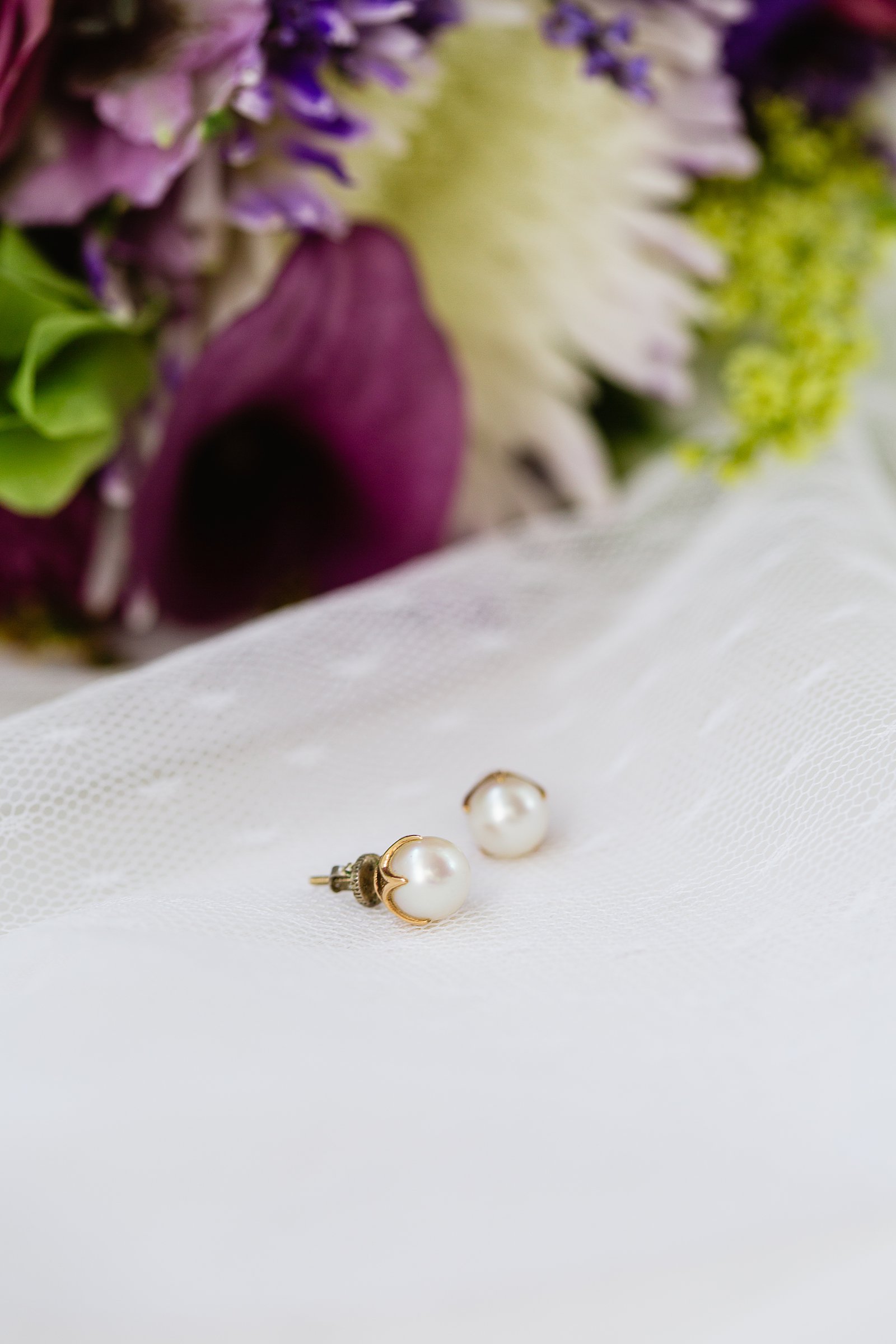 Brides's wedding day details of vintage pearl earrings by PMA Photography.