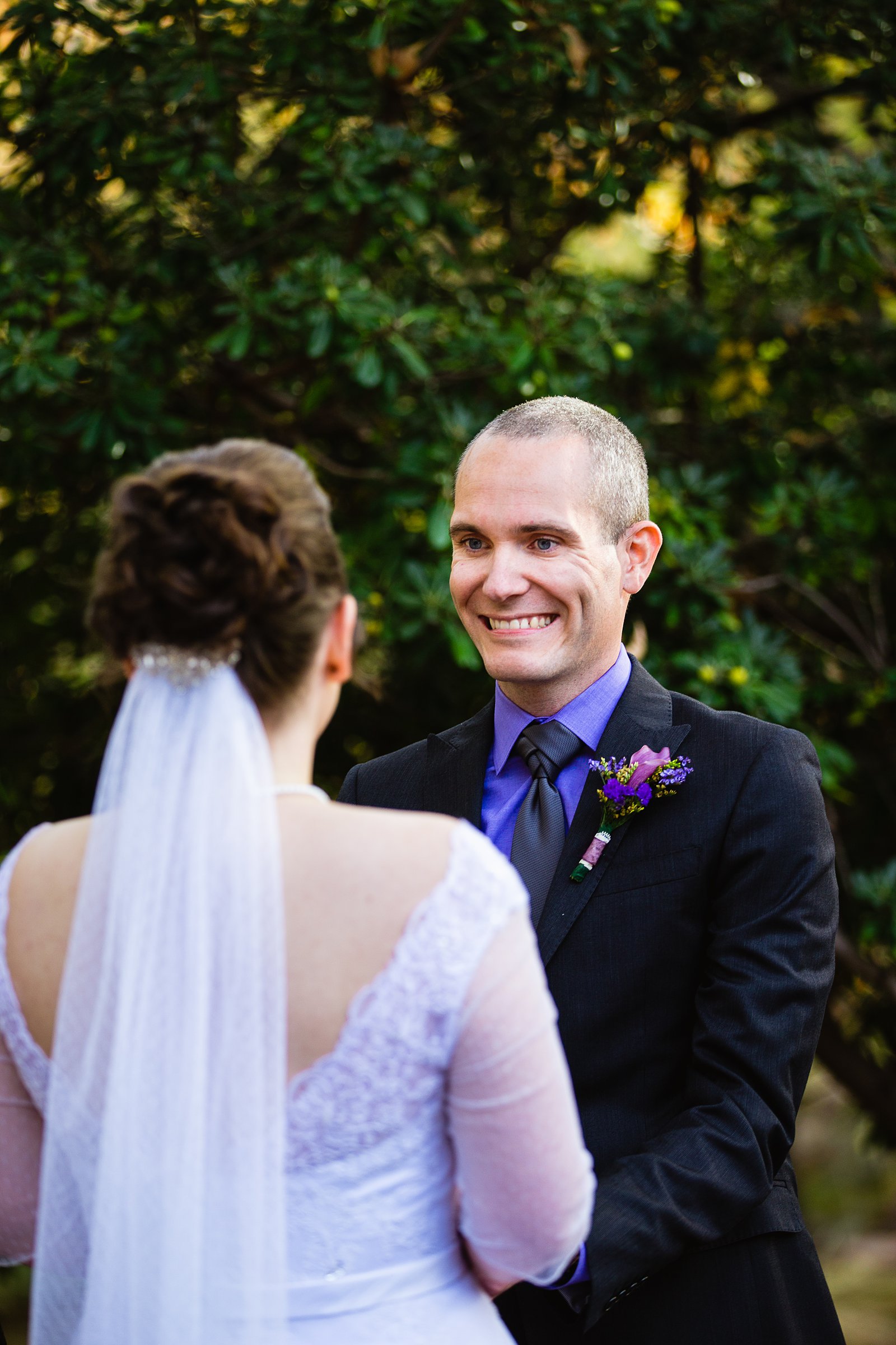 Groom looking at his bride during their wedding ceremony at L'Auberge de Sedona by Sedona wedding photographer PMA Photography.