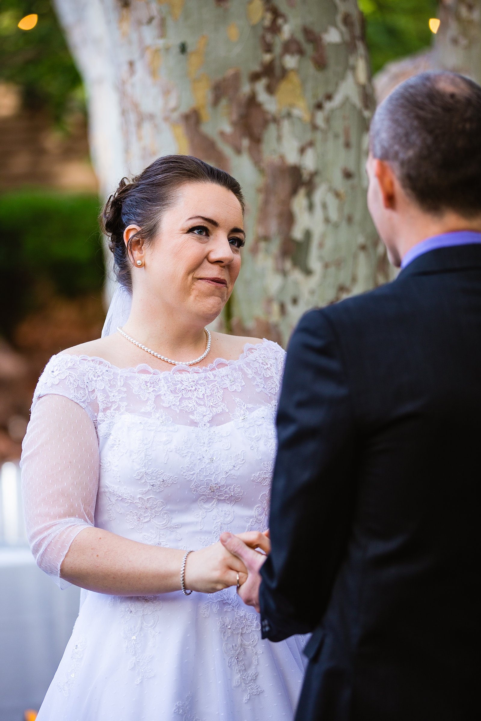 Bride looking at her groom during their wedding ceremony at L'Auberge de Sedona by Sedona wedding photographer PMA Photography.