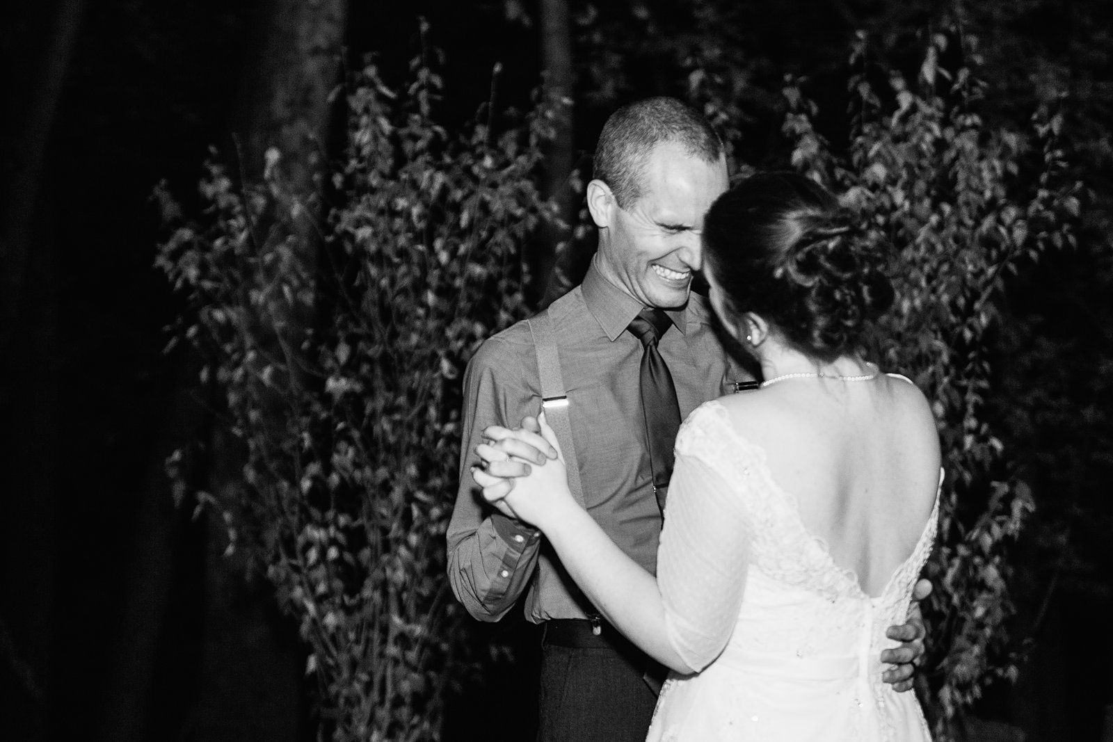 Bride and groom sharing first dance at their L'Auberge de Sedona wedding reception by Arizona wedding photographer PMA Photography.