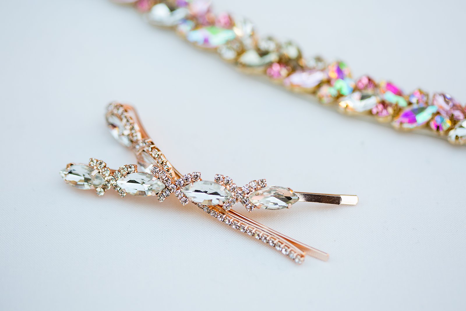 Brides's wedding day details of rose gold hair clips by PMA Photography.