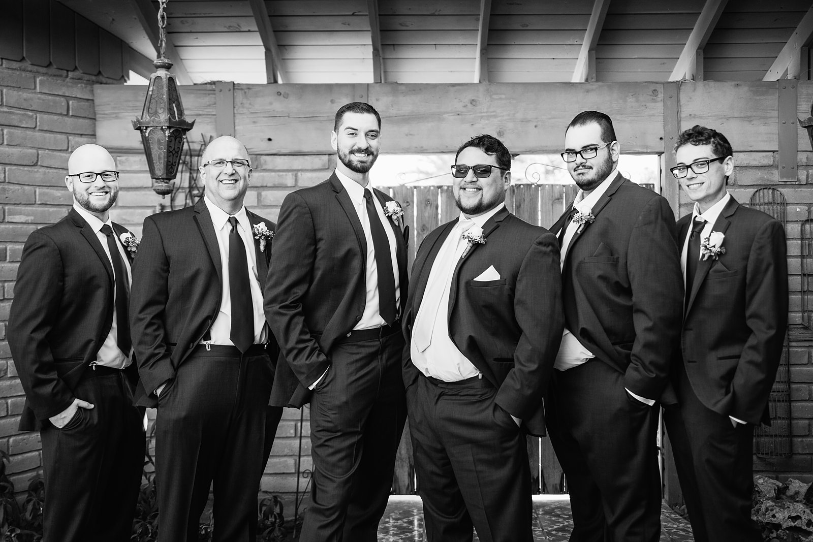 Groom and groomsmen together at a Backyard wedding by Arizona wedding photographer PMA Photography.