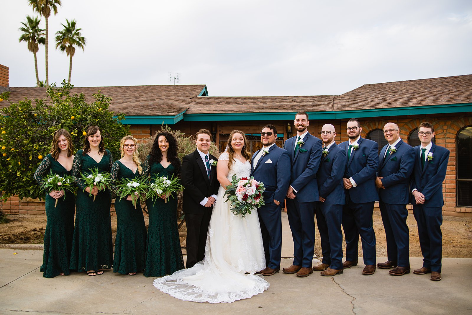 Bridal party together at a Backyard wedding by Arizona wedding photographer PMA Photography.