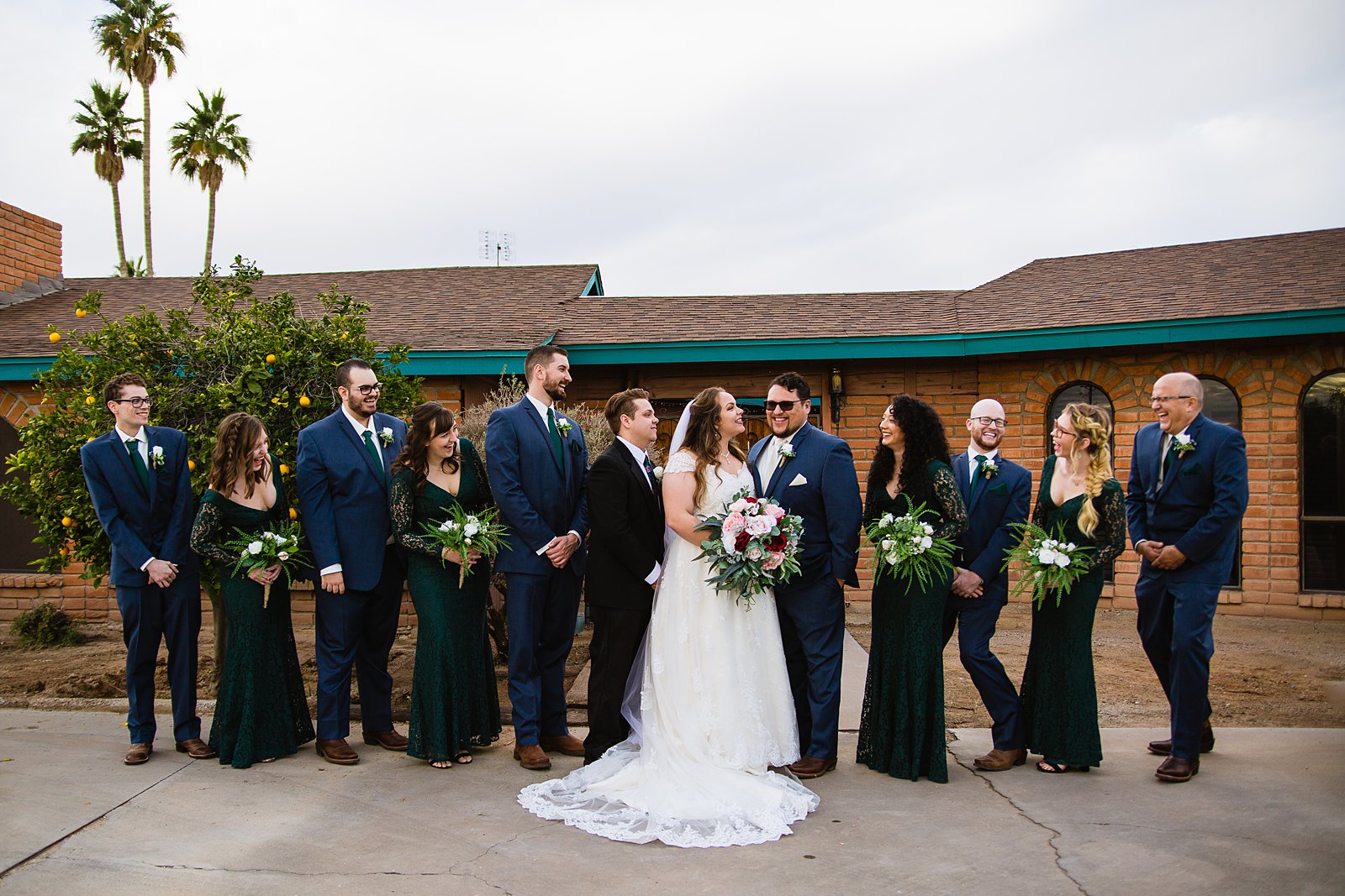 Bridal party laughing together at Backyard wedding by Casa Grande wedding photographer PMA Photography.
