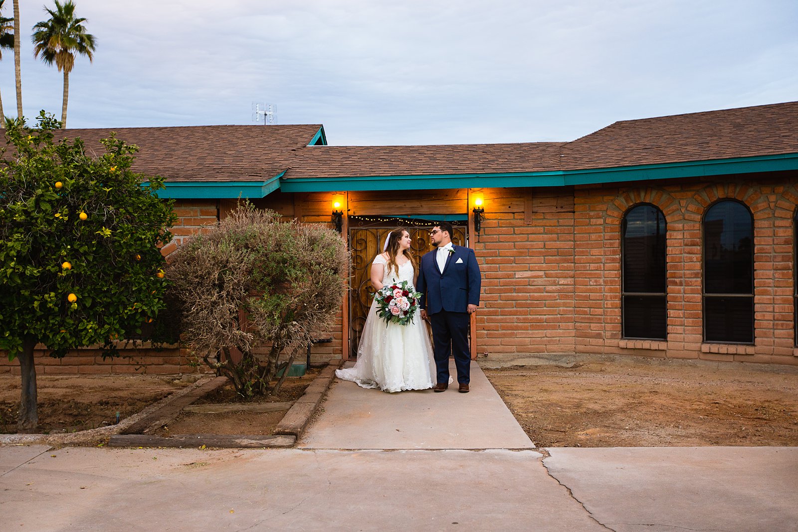 Bride and Groom pose for their Backyard wedding by Casa Grande wedding photographer PMA Photography.