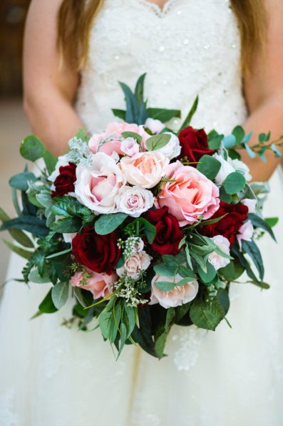 Bride's DIY red and pink bouquet by PMA Photography.