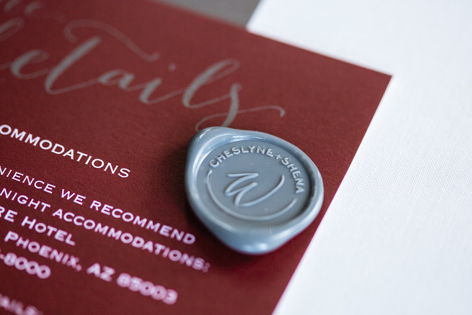 Custom wedding wax seal on burgundy and grey wedding invitations by PMA Photography.