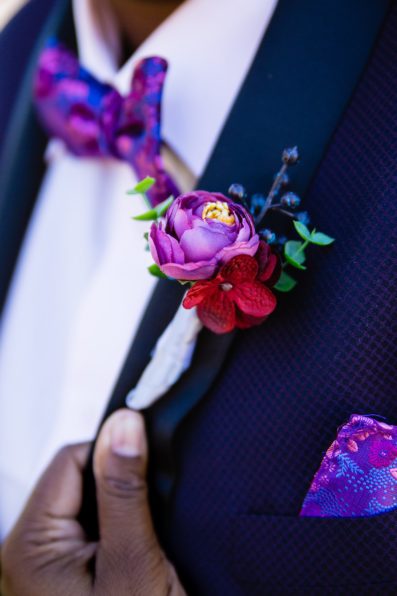 Bride's colorful purple boutonniere by PMA Photography.