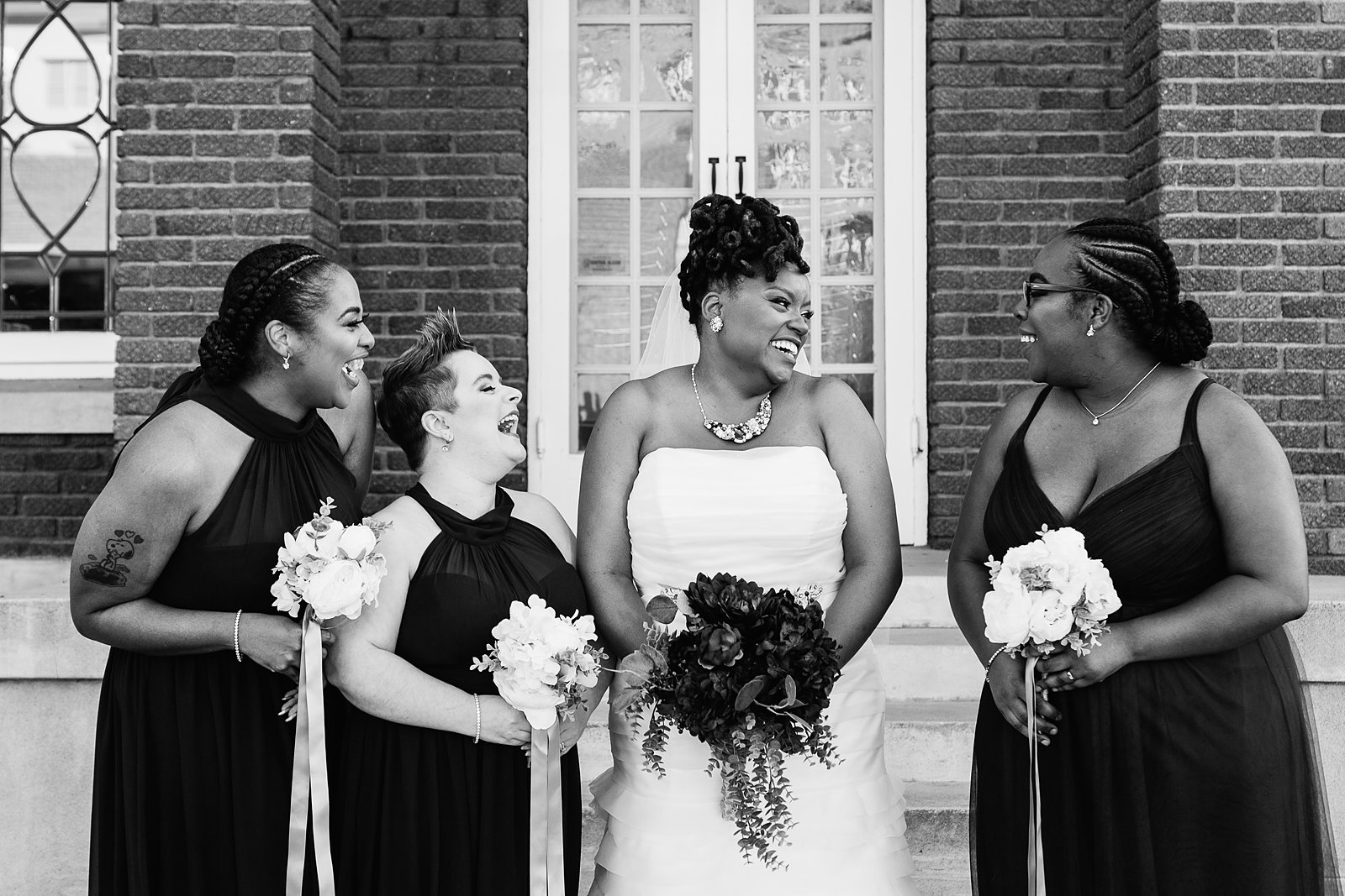 Bride and bridesmaids laughing together at Ellis-Shackelford House wedding by Phoenix wedding photographer PMA Photography.