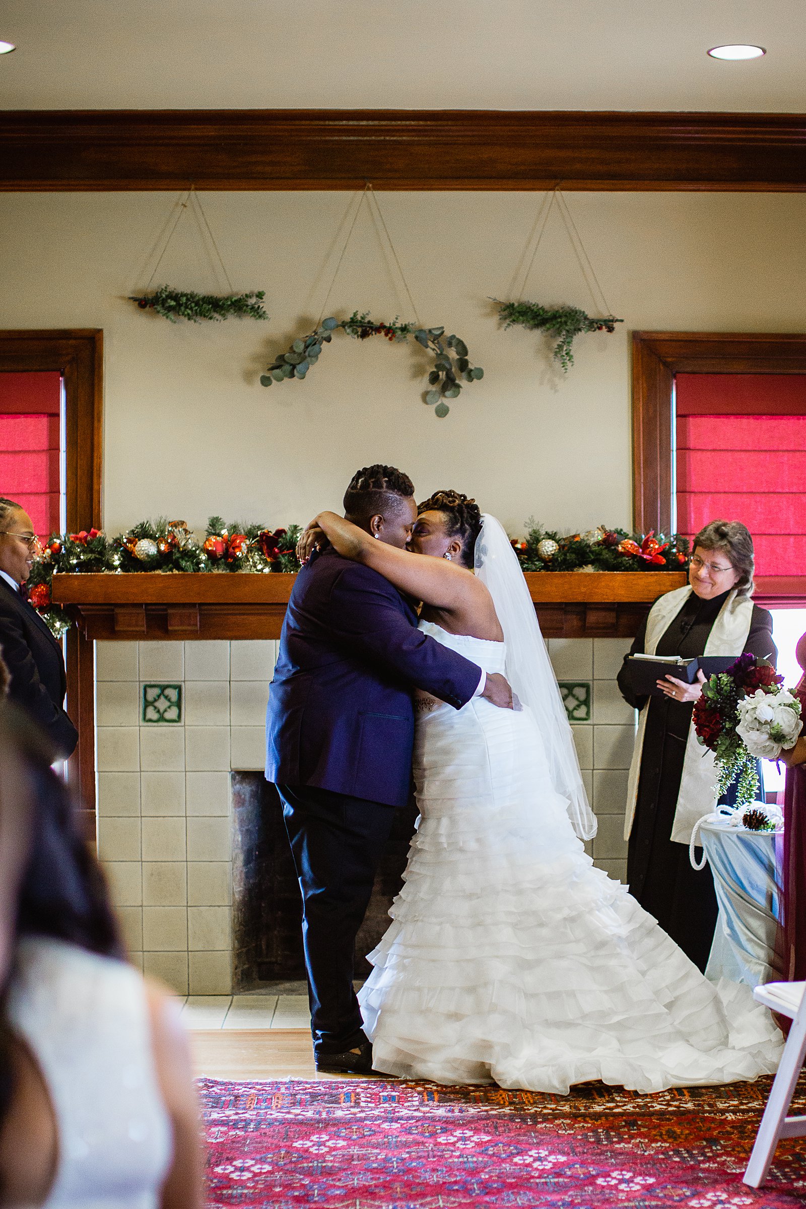 Same sex couple share their first kiss during their wedding ceremony at Ellis-Shackelford House by Arizona wedding photographer PMA Photography.