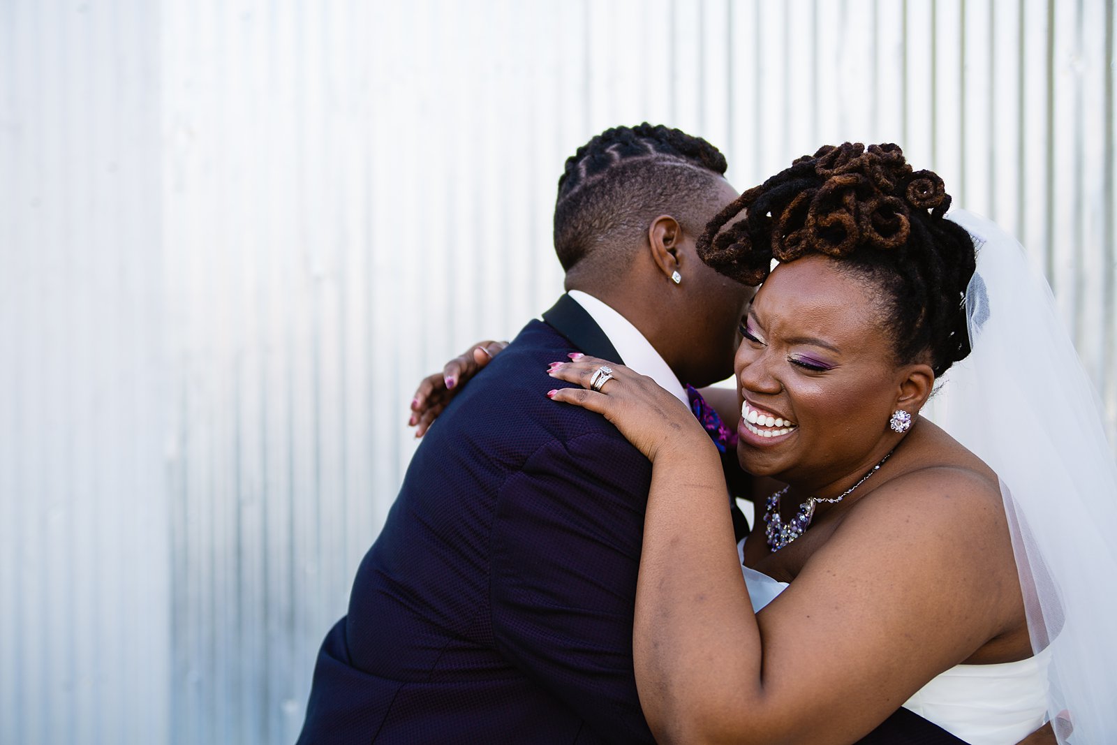 Same sex couple laughing together during their Ellis-Shackelford House wedding by Phoenix wedding photographer PMA Photography.