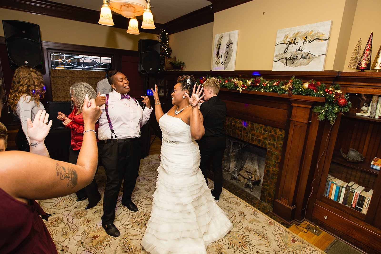Same sex couple dancing with guests at their Ellis-Shackelford House wedding reception by Arizona wedding photographer PMA Photography